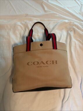 Coach 38” Canvas Duffel Tote in Tan with Red-Trim Handles with original tag.